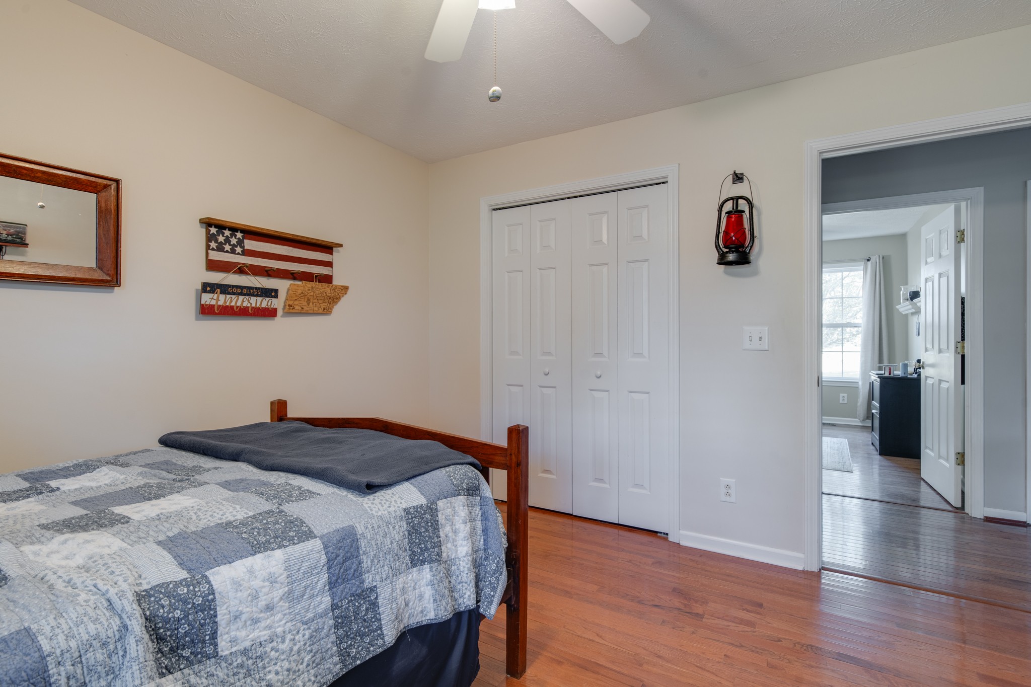 6699 East Benton Road Springfield, TN 37172 - Photo 37 of 66 a bedroom with a bed and a chandelier