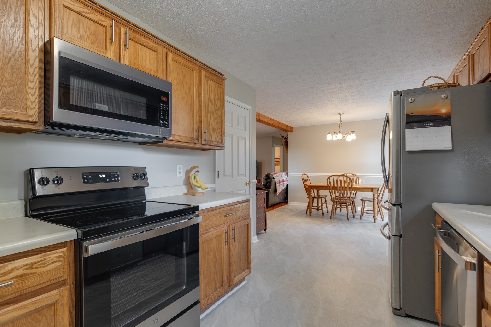 6699 East Benton Road Springfield, TN 37172 - Photo 47 of 66 a kitchen with stainless steel appliances a stove a microwave a sink and cabinets