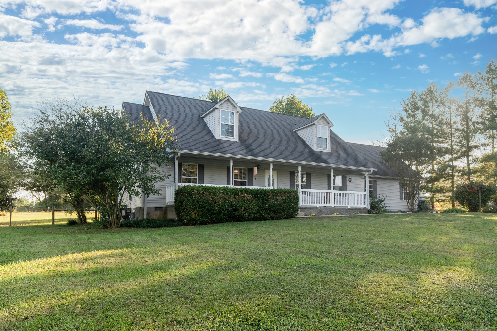 6699 East Benton Road Springfield, TN 37172 - Photo 66 of 66 a view of a yard in front of a brick house with a large tree