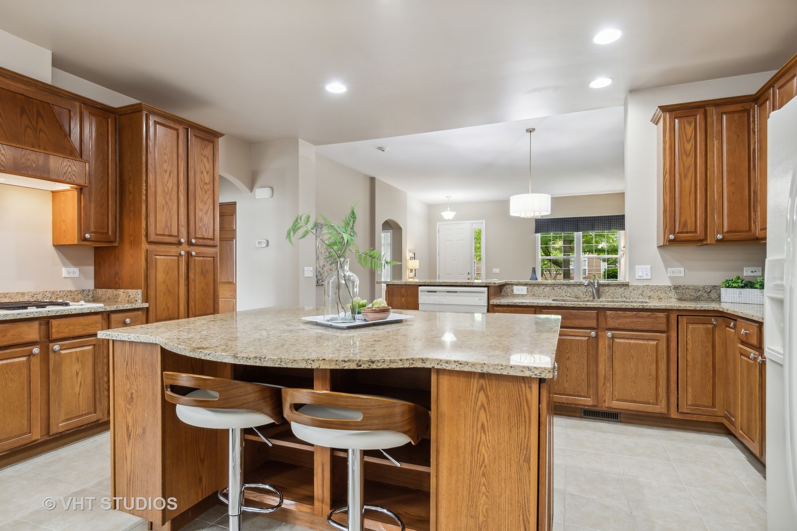 2934 Portage Street Naperville, IL 60564 - Photo 6 of 30 a kitchen with kitchen island granite countertop a table chairs sink and cabinets