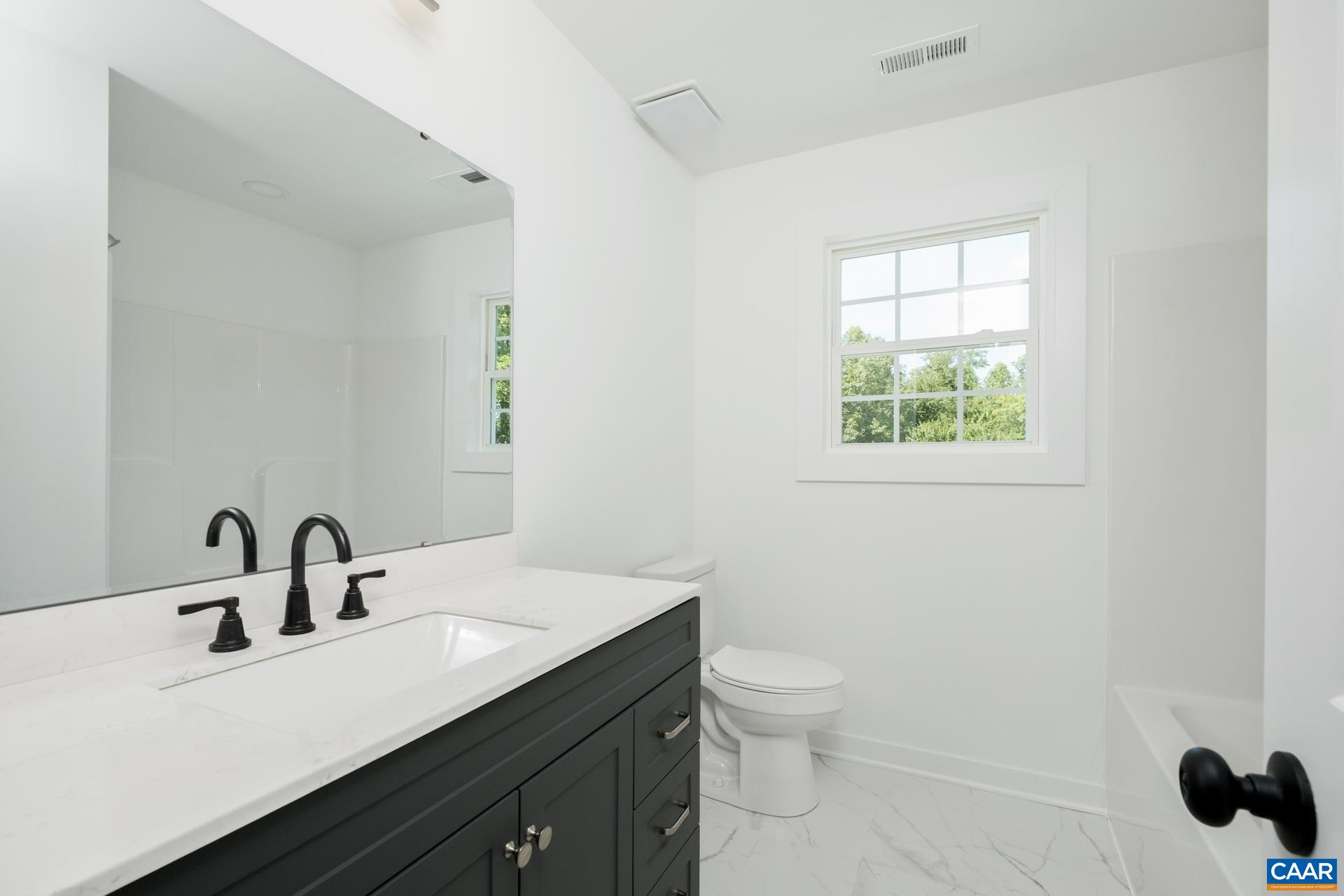 2211 Carpenters Mill Road Ruckersville, VA 22968 - Photo 20 of 25 a bathroom with a toilet sink and mirror