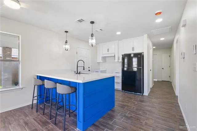 a kitchen with stainless steel appliances a sink stove and refrigerator