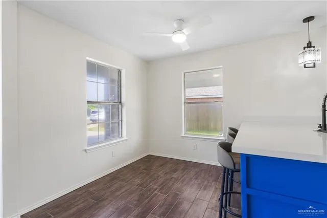 a workspace with wooden floor and windows