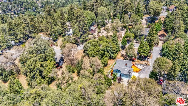 an aerial view of a house with a yard and swimming pool
