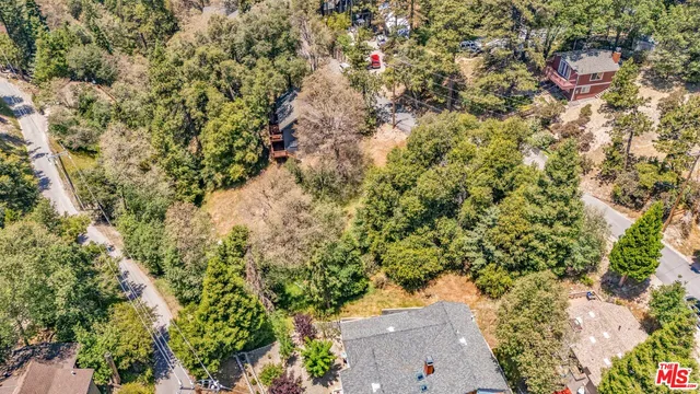 an aerial view of a houses with yard