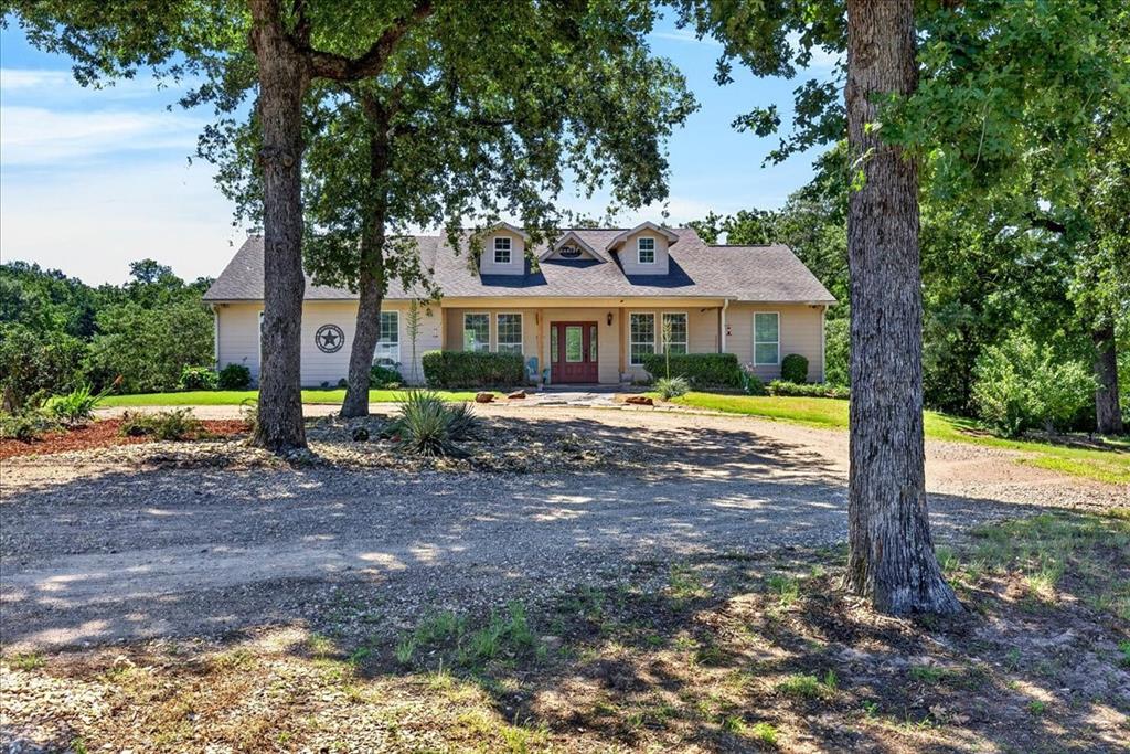 11591 Farm To Market 59 Athens, TX 75751 - Photo 3 of 40 Traditional-style residence featuring a dormer roofline, covered porch, and a gravel driveway