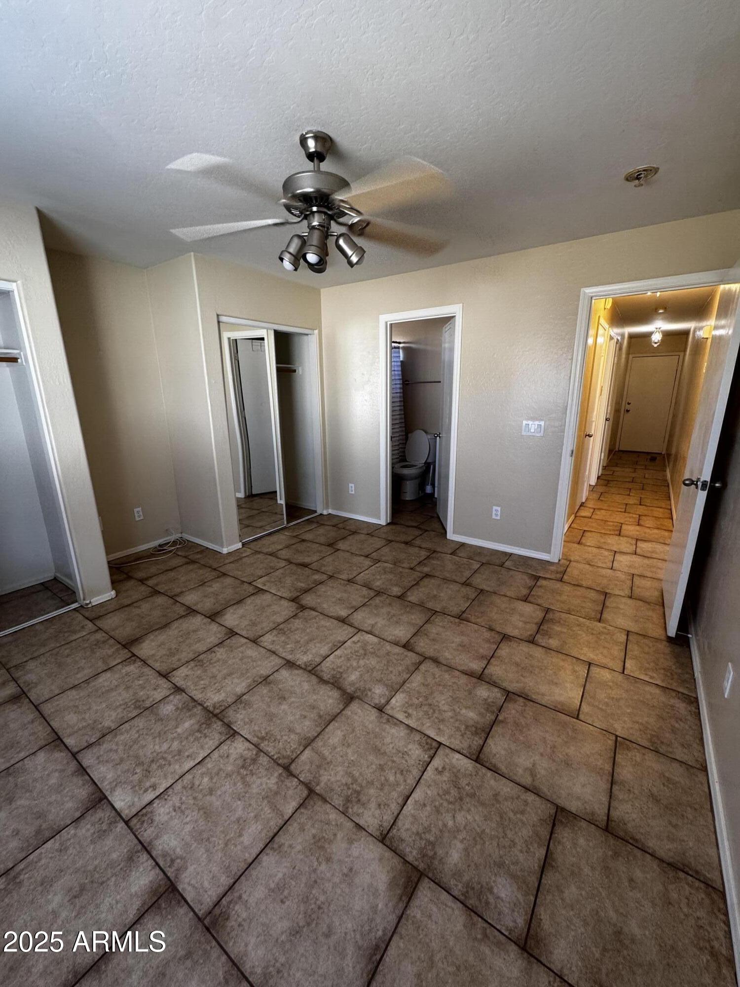 12817 North El Frio Street El Mirage, AZ 85335 - Photo 15 of 16 a view of a hallway with a chandelier