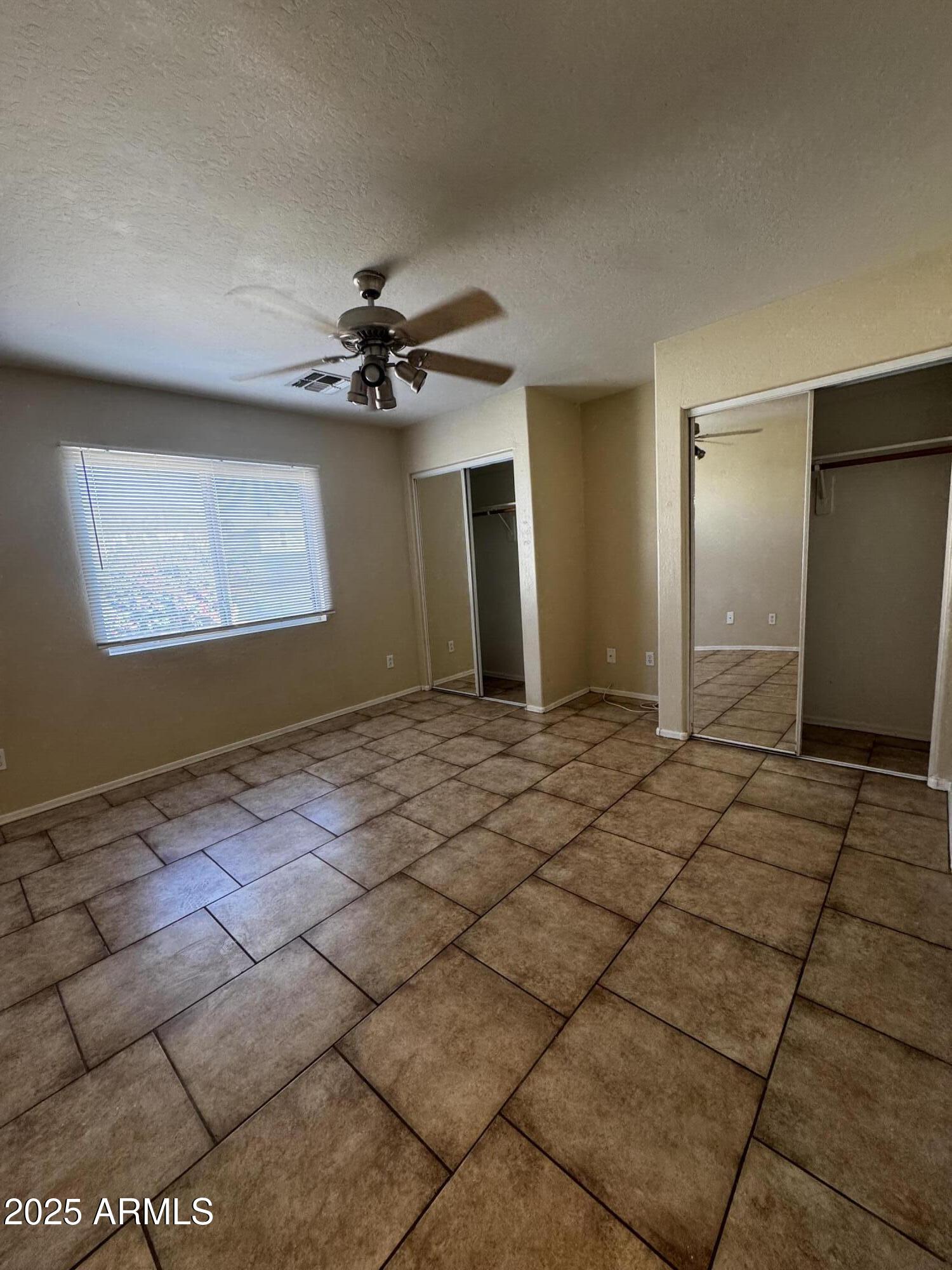 12817 North El Frio Street El Mirage, AZ 85335 - Photo 16 of 16 a view of a livingroom with a chandelier fan and windows