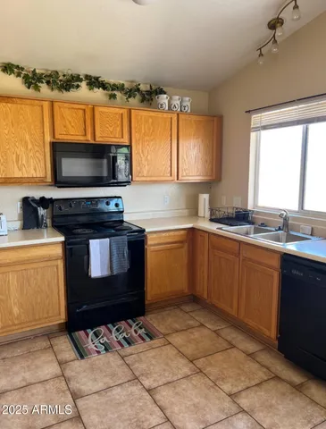 a kitchen with a stove a sink and a microwave