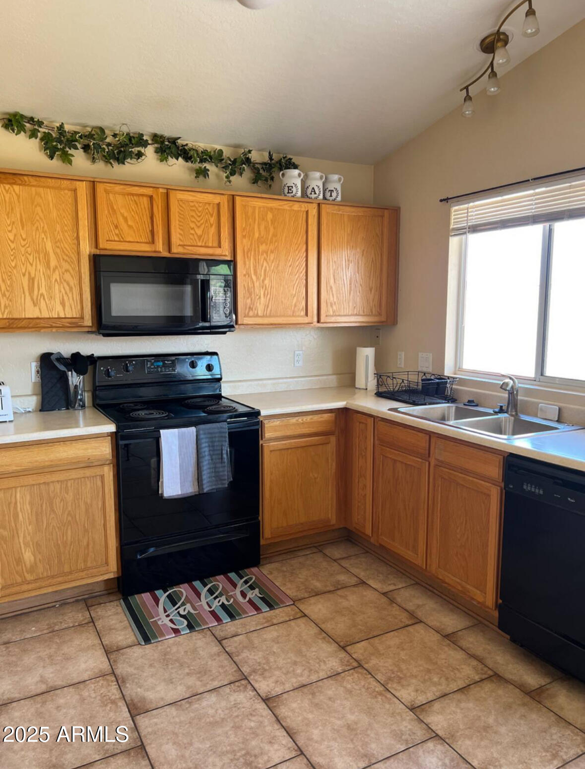 12817 North El Frio Street El Mirage, AZ 85335 - Photo 2 of 16 a kitchen with a stove a sink and a microwave