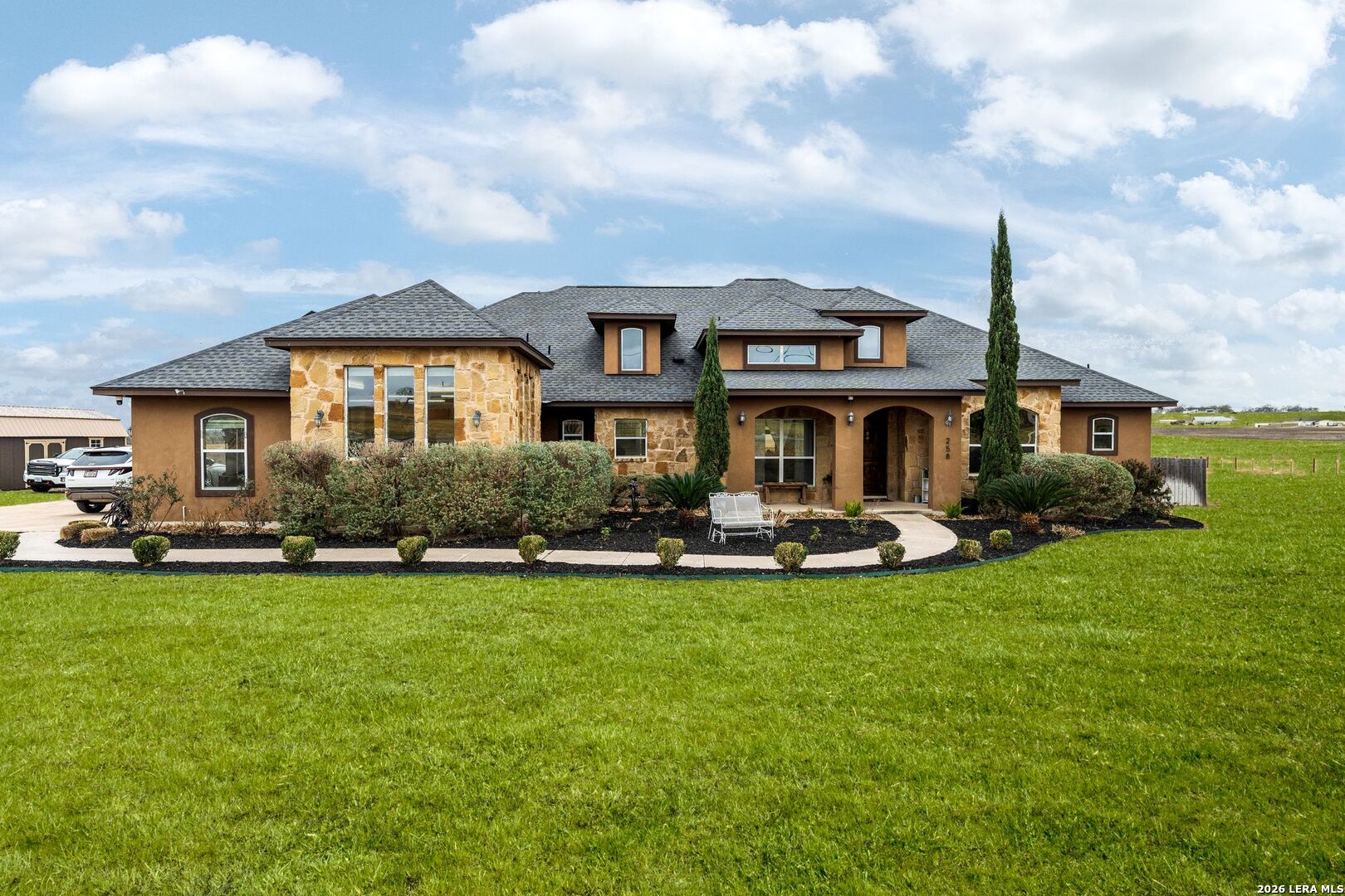 a front view of a house with swimming pool having outdoor seating