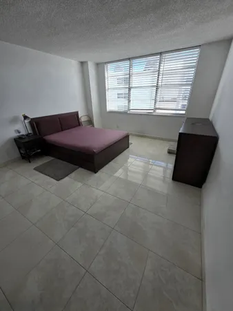a room with a bed and a window