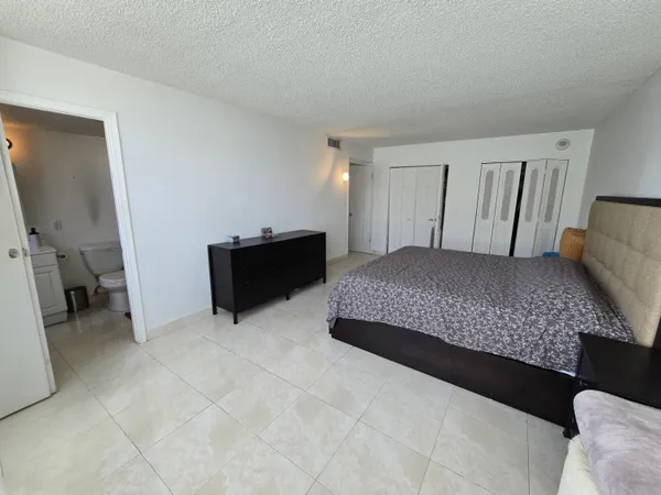 a bedroom with a bed and dresser