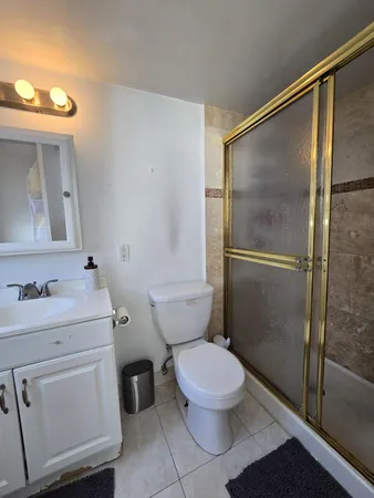 a white toilet sitting next to a bathroom sink