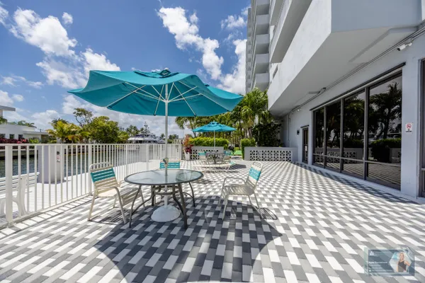 a view of a patio with a table and chairs