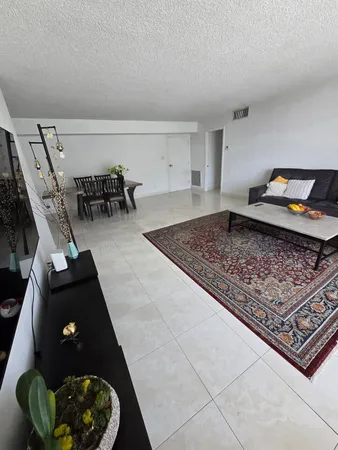 a living room with furniture and a rug