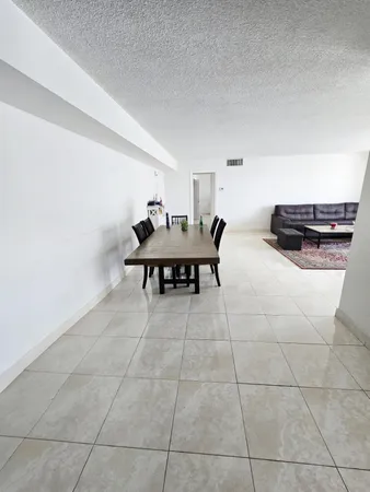 a living room with couches a table and a stove top oven
