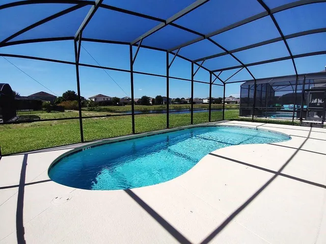 an aerial view of residential houses with outdoor space and swimming pool