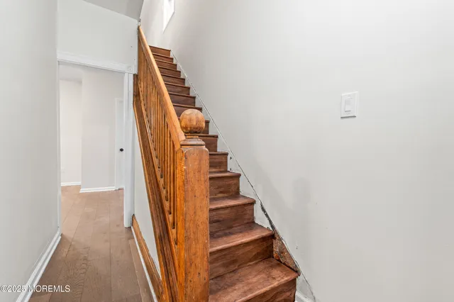 a view of staircase with wooden floor
