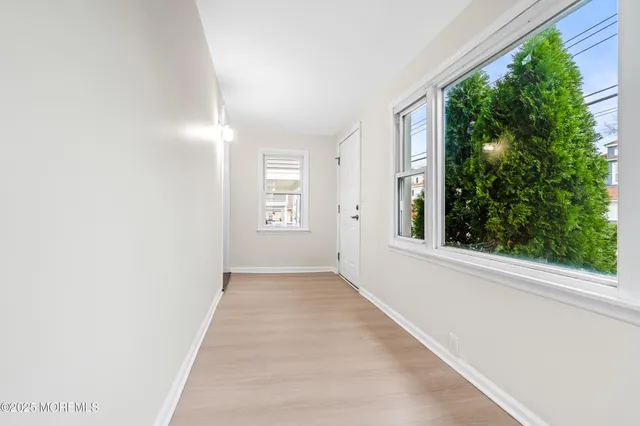 an empty room with windows and yard