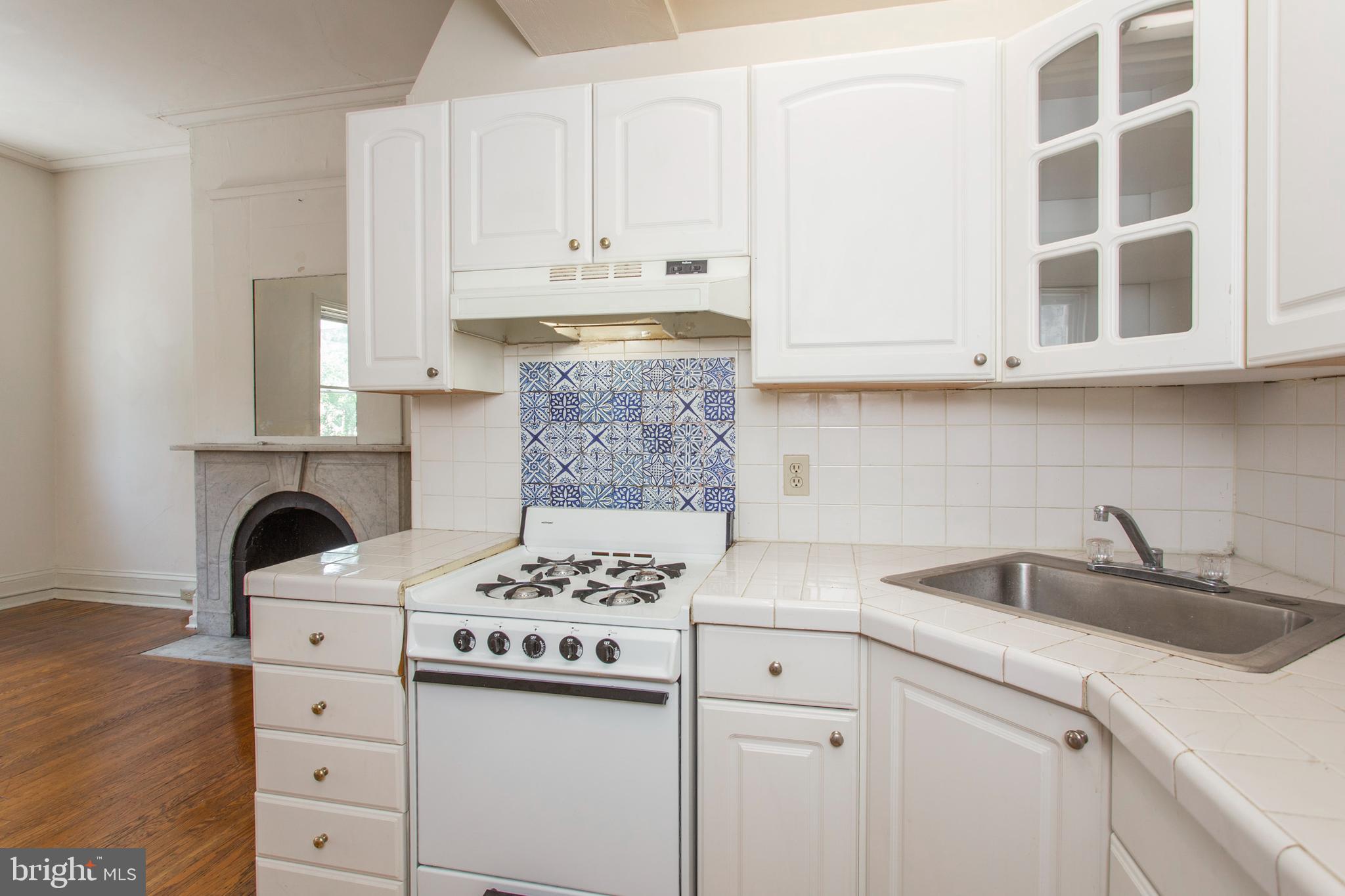 1807 Spruce Street, Unit 2F Philadelphia, PA 19103 - Photo 8 of 17 a kitchen with white cabinets and appliances
