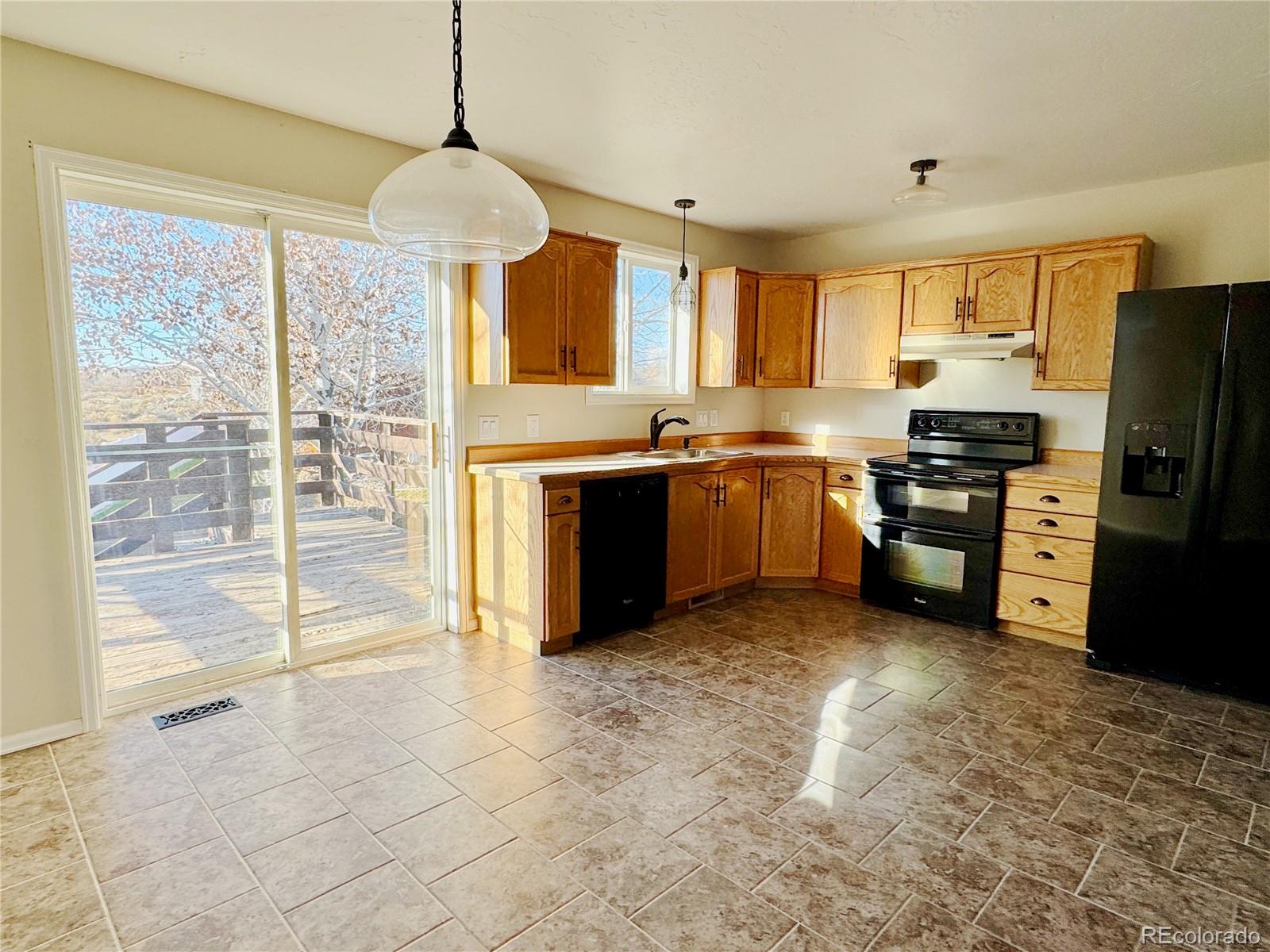 401 Rider Road Rangely, CO 81648 - Photo 11 of 23 a large kitchen with cabinets and stainless steel appliances