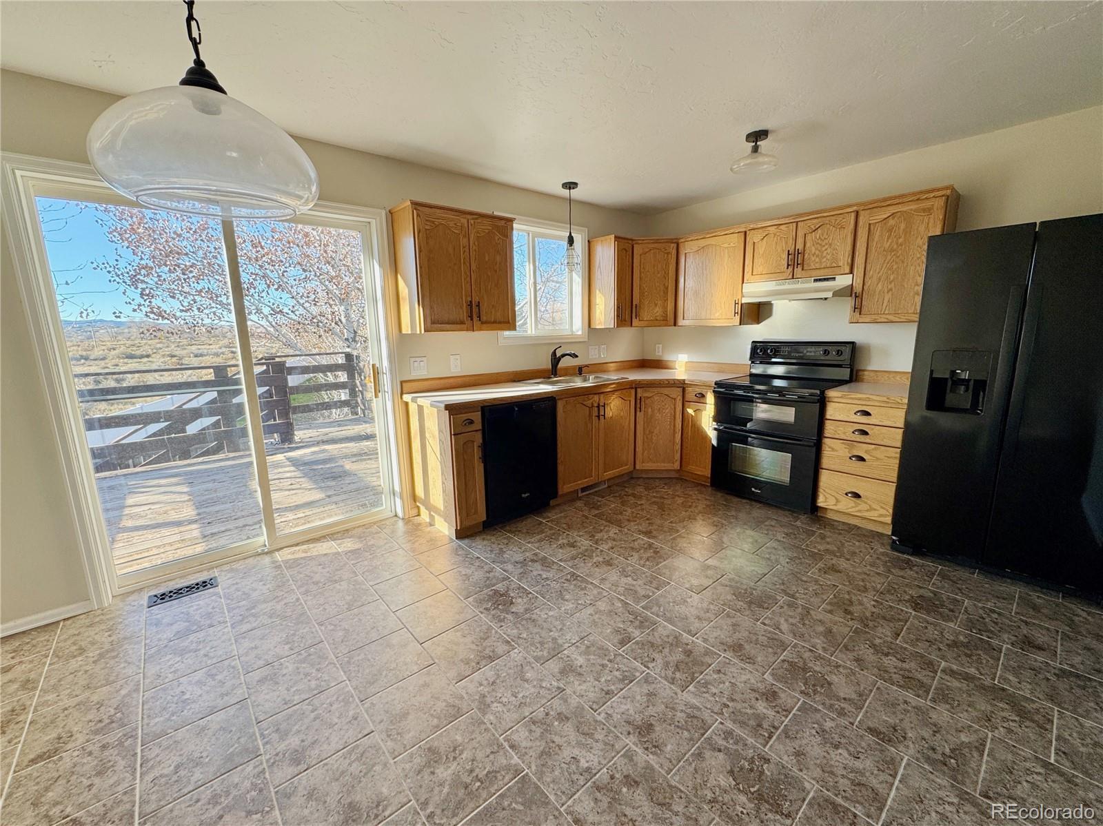 401 Rider Road Rangely, CO 81648 - Photo 12 of 23 a large kitchen with cabinets and stainless steel appliances