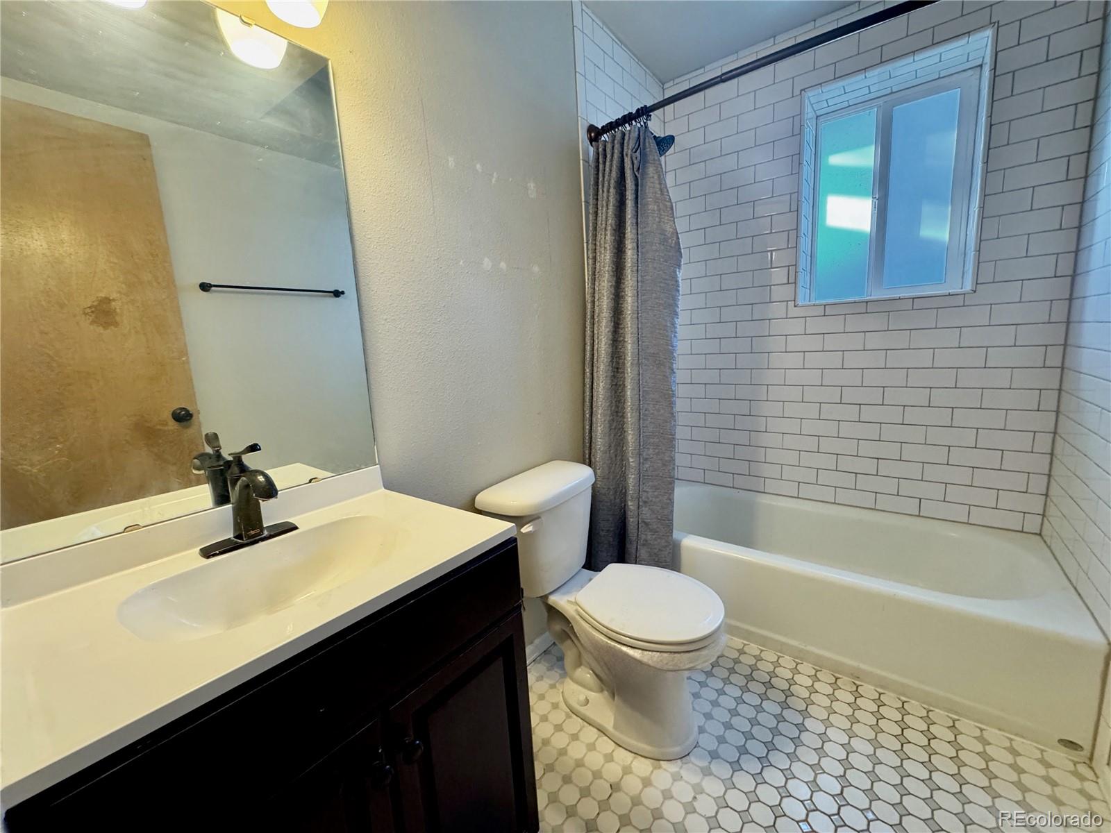 401 Rider Road Rangely, CO 81648 - Photo 16 of 23 a bathroom with a sink a toilet and shower