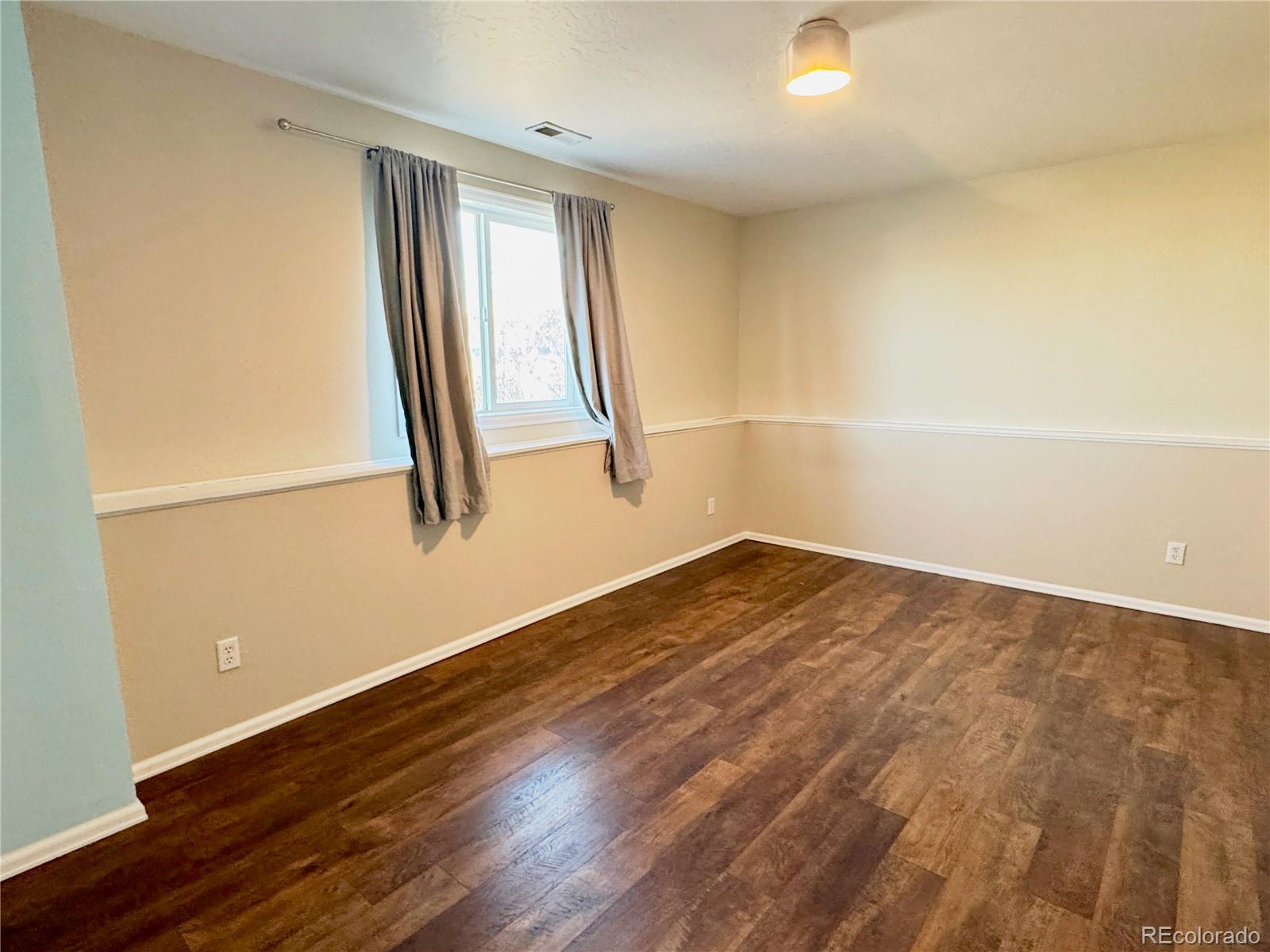 401 Rider Road Rangely, CO 81648 - Photo 18 of 23 a view of a room with wooden floor and white walls