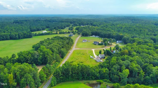 an aerial view of a houses with a yard