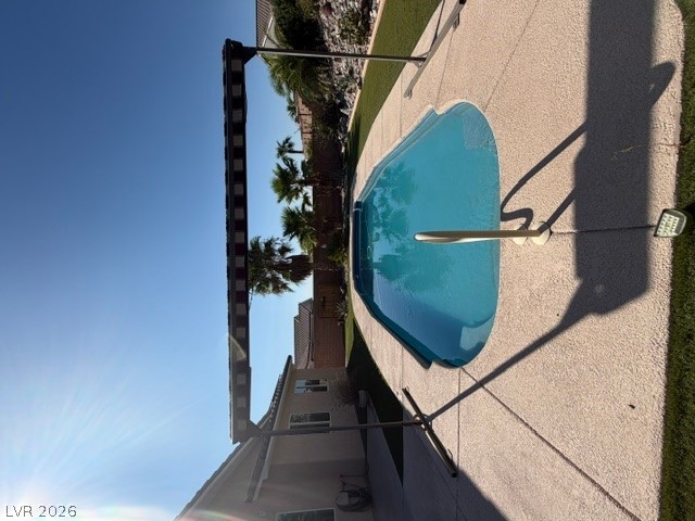 2485 Morrow Ridge Place Laughlin, NV 89029 - Photo 34 of 39 An inviting backyard oasis features a sparkling in-ground pool surrounded by textured decking.