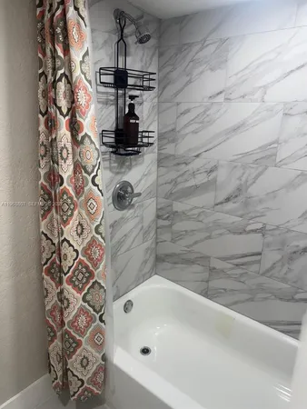 a bathroom with a bathtub and shower