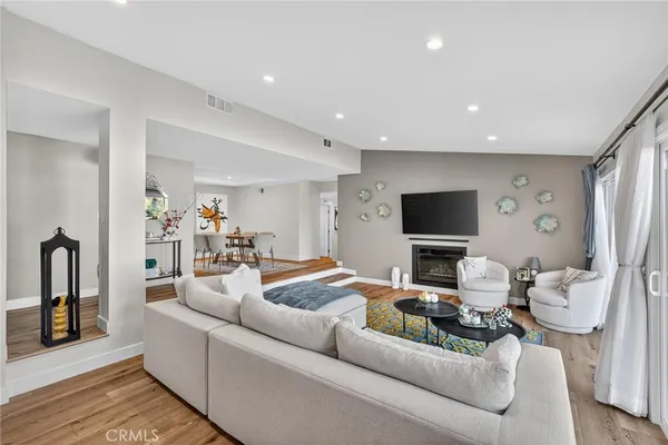 a living room with furniture and a floor to ceiling window