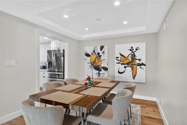 a kitchen with stainless steel appliances white cabinets and a window