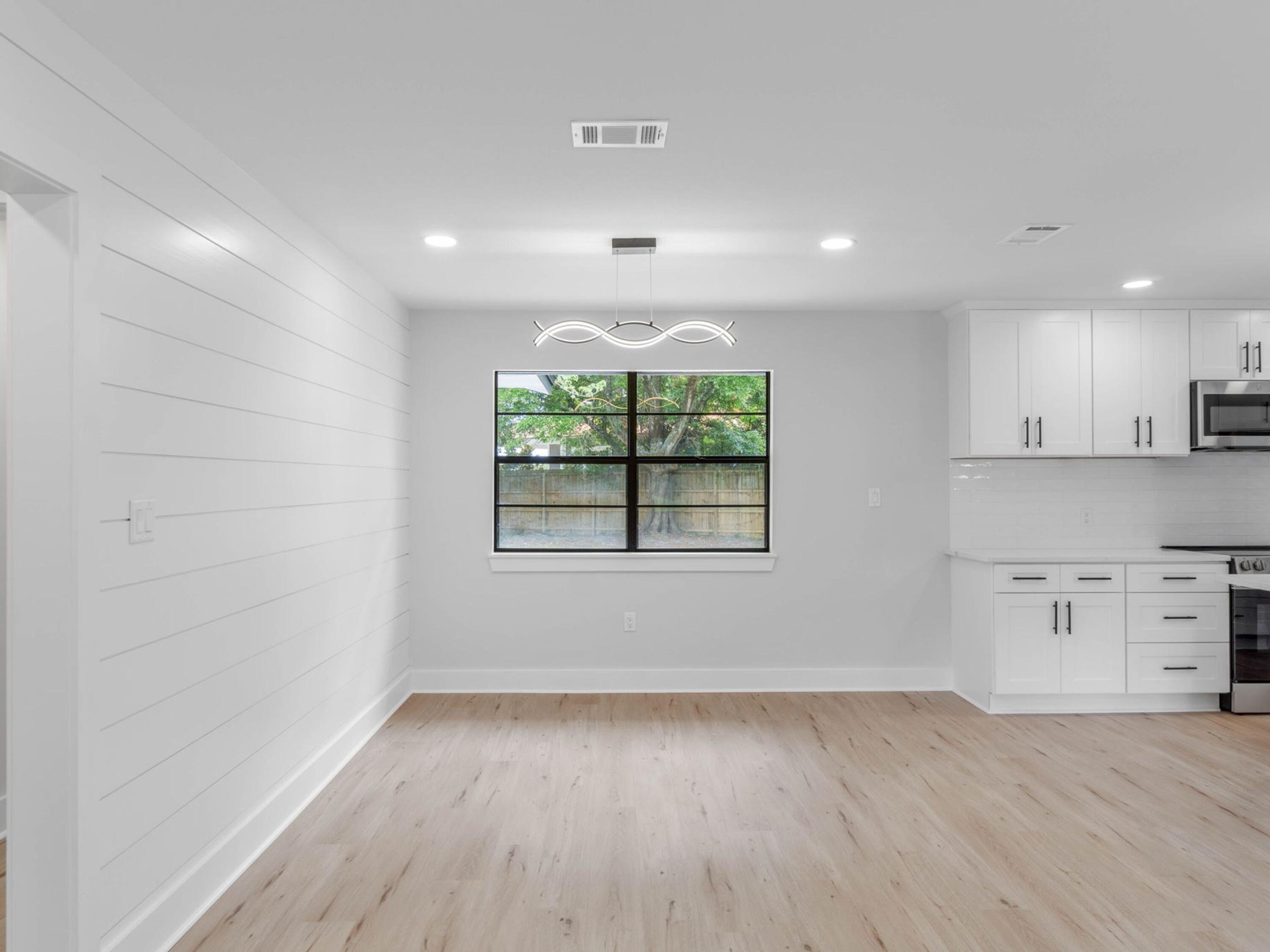 609 Sea View Circle Destin, FL 32541 - Photo 12 of 45 an empty room with wooden floor and windows