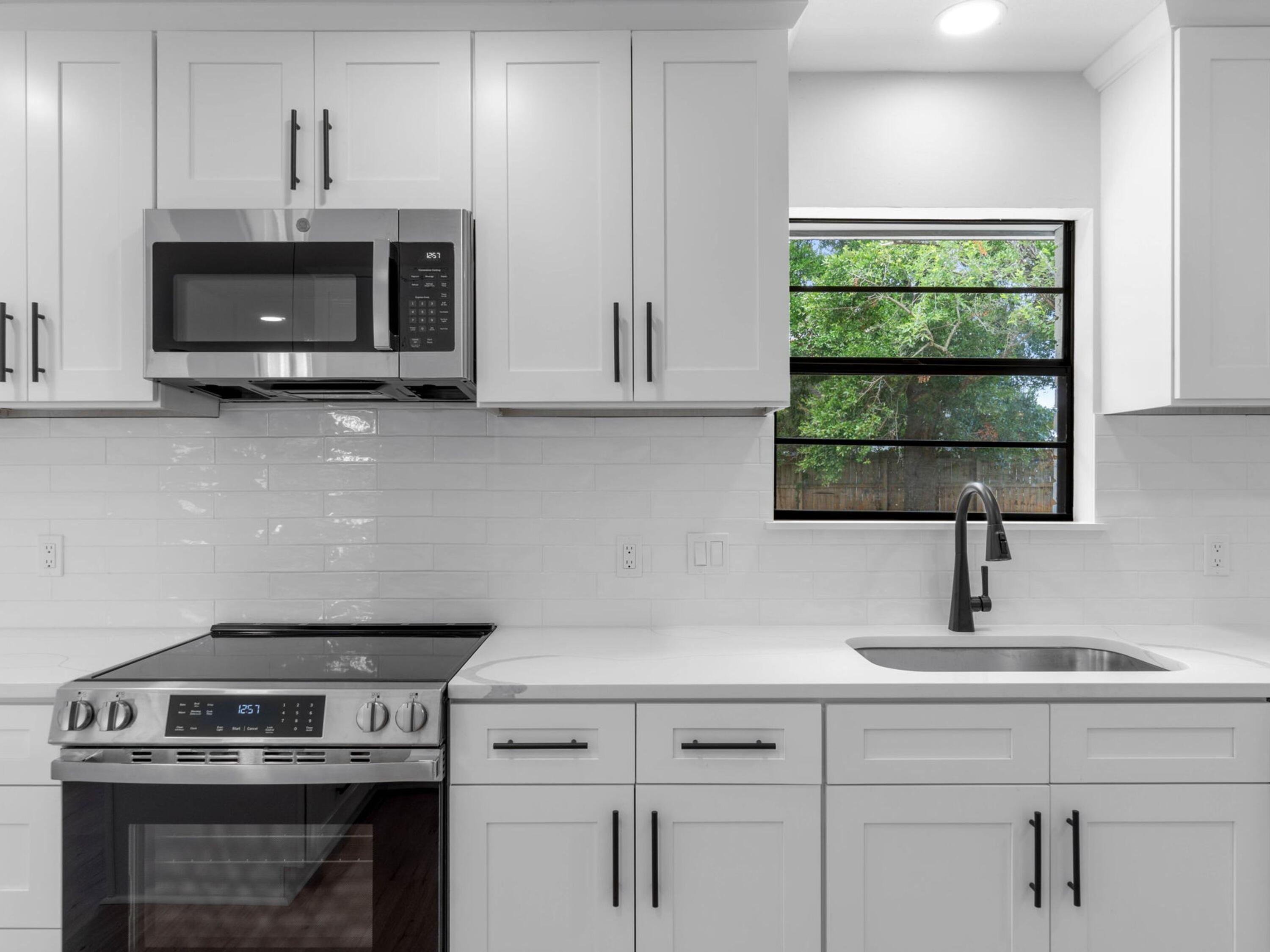 609 Sea View Circle Destin, FL 32541 - Photo 19 of 45 a kitchen with a stove and a microwave