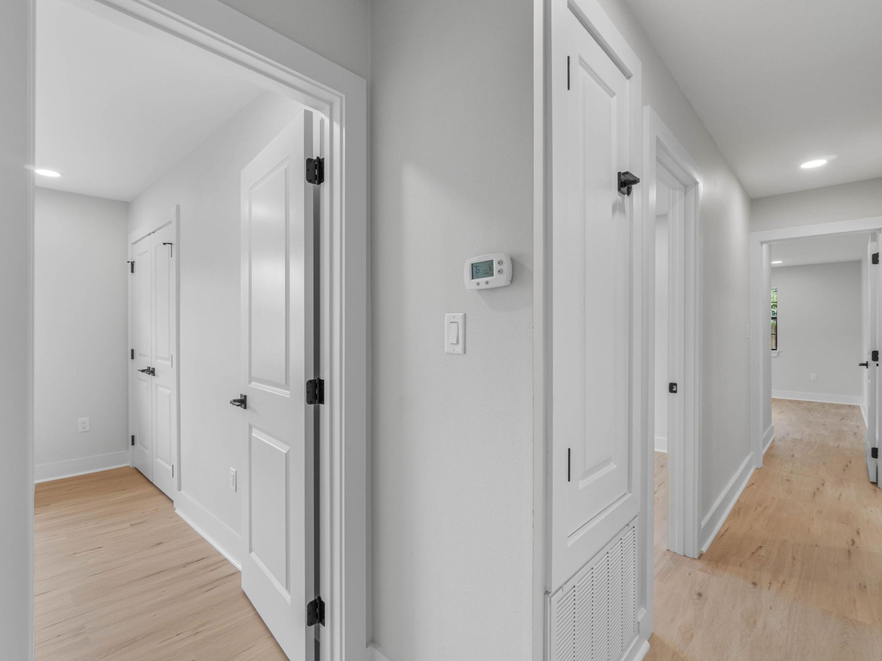 609 Sea View Circle Destin, FL 32541 - Photo 22 of 45 a view of a hallway with wooden floor and a bathroom