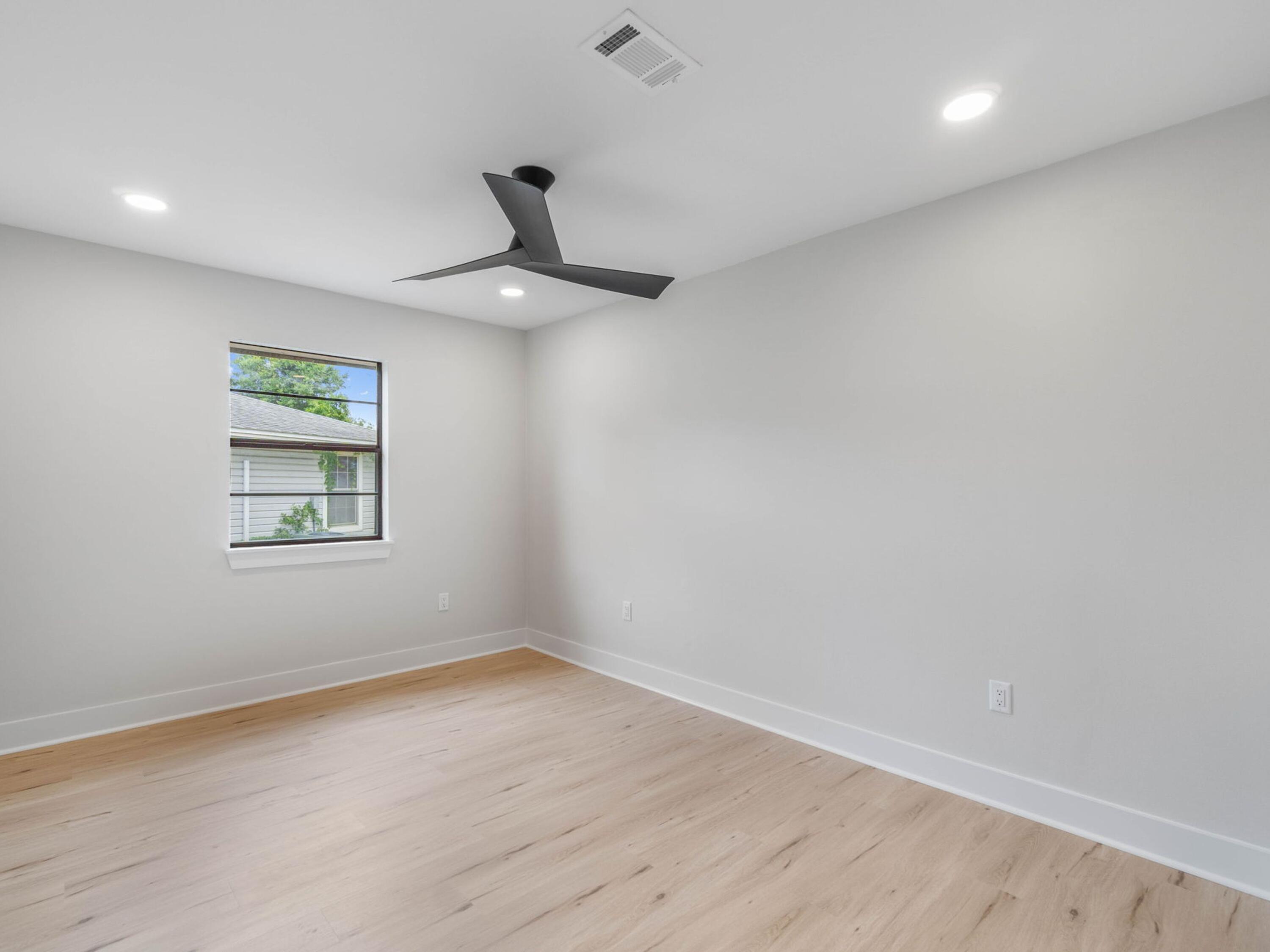 609 Sea View Circle Destin, FL 32541 - Photo 26 of 45 a view of an empty room with a window and wooden floor