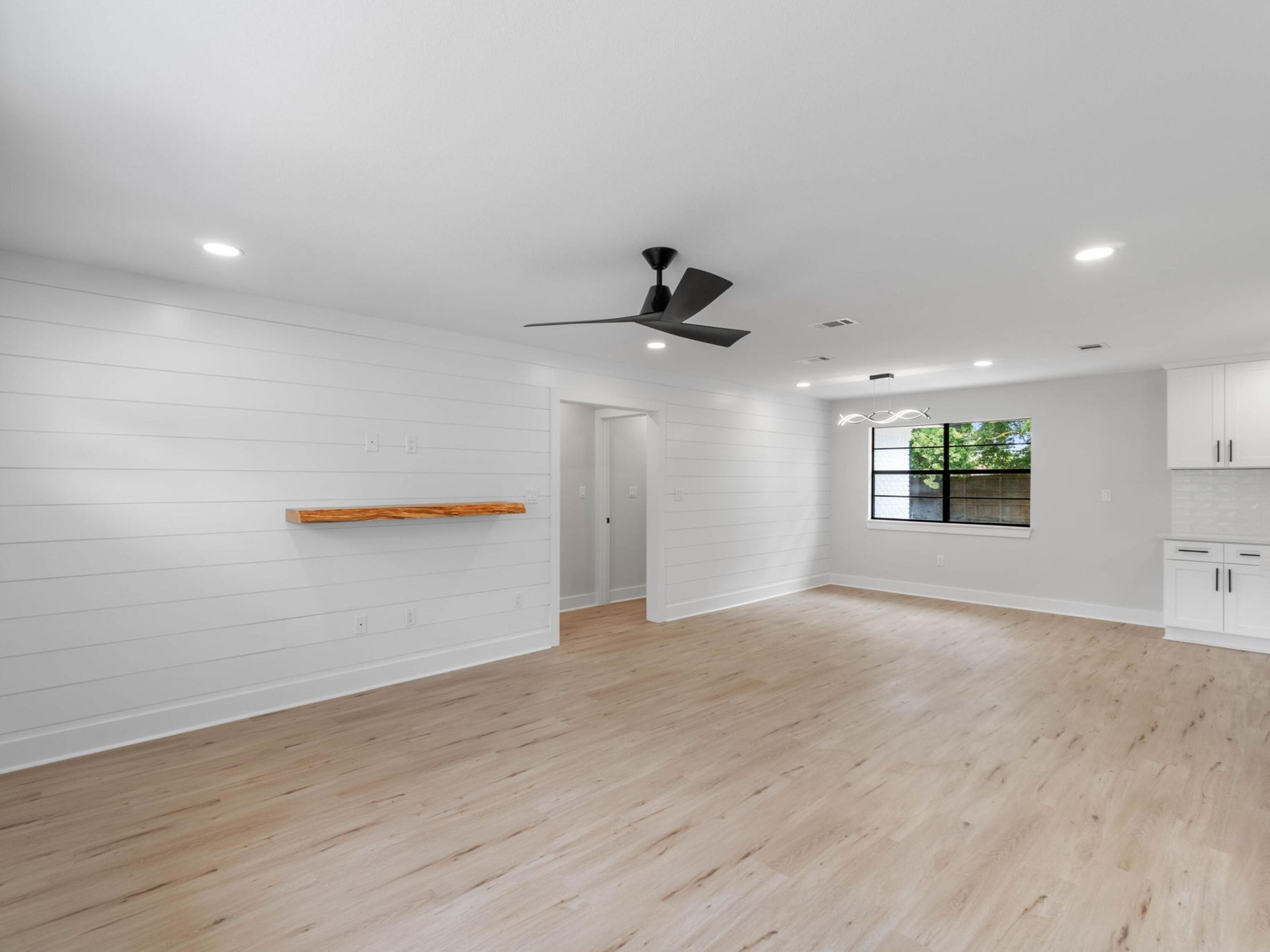 609 Sea View Circle Destin, FL 32541 - Photo 6 of 45 an empty room with wooden floor and windows