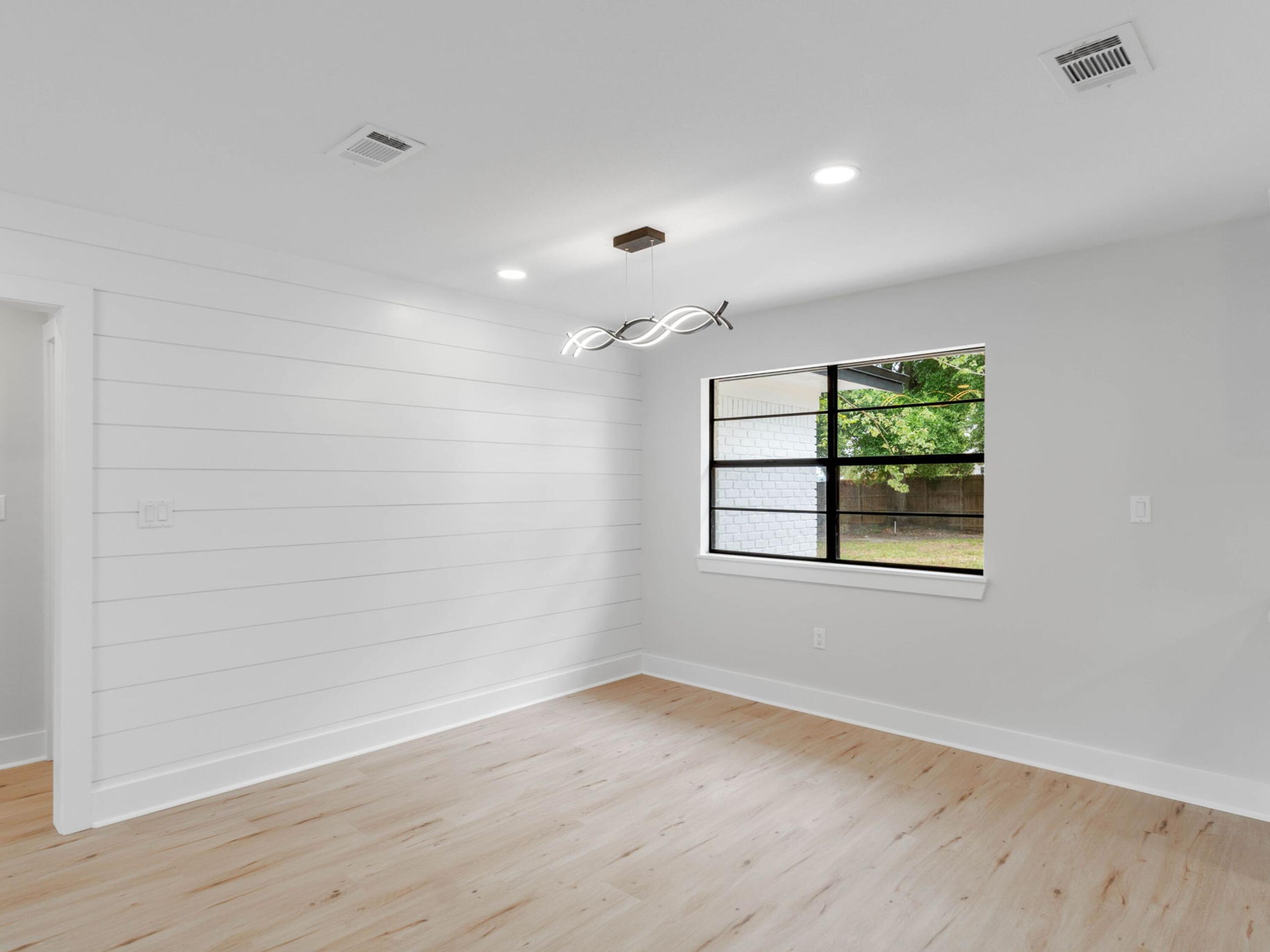 609 Sea View Circle Destin, FL 32541 - Photo 10 of 45 an empty room with wooden floor and windows