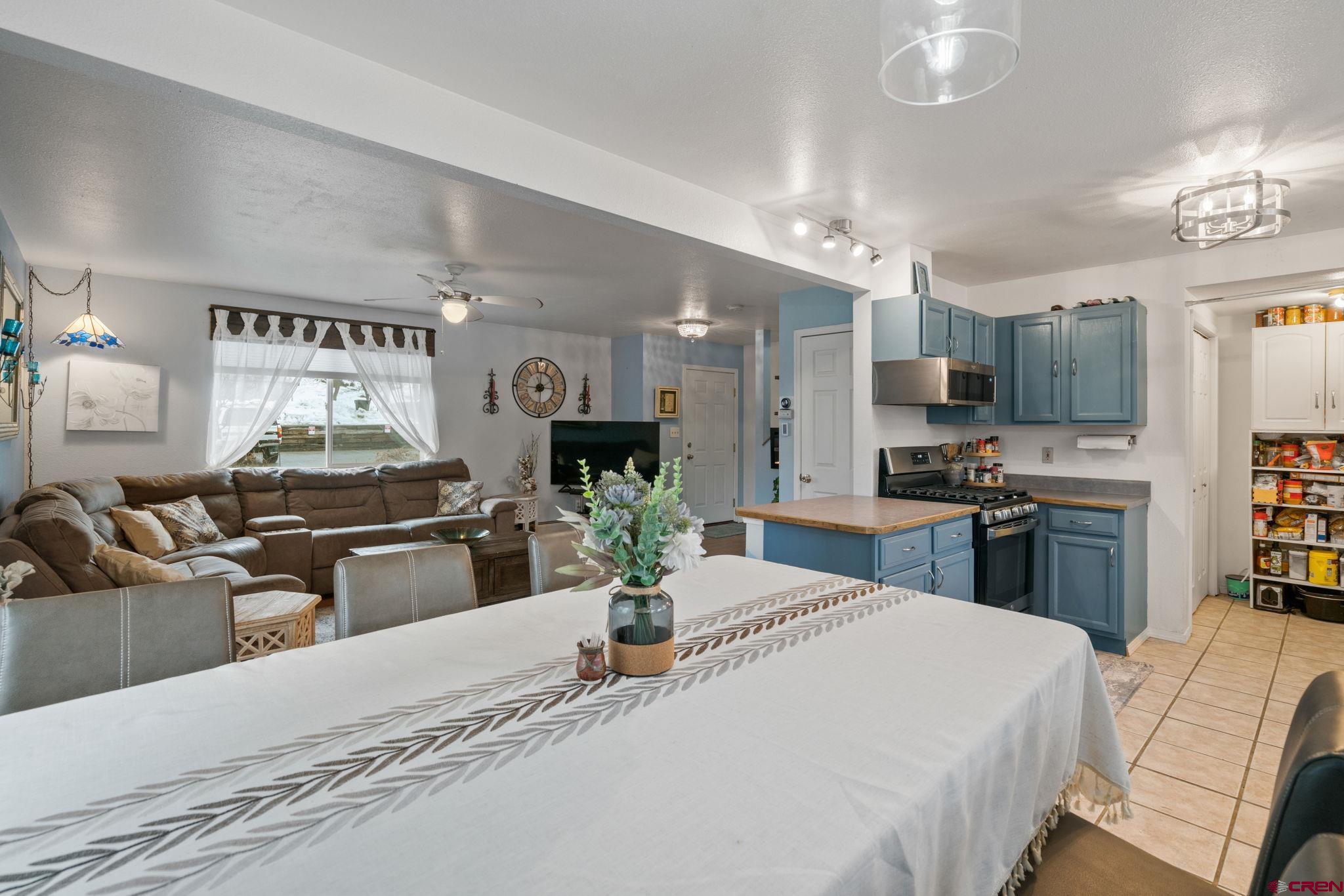 233 Jenkins Ranch Road, Unit B Durango, CO 81301 - Photo 6 of 20 a kitchen with stainless steel appliances kitchen island granite countertop a stove and cabinets