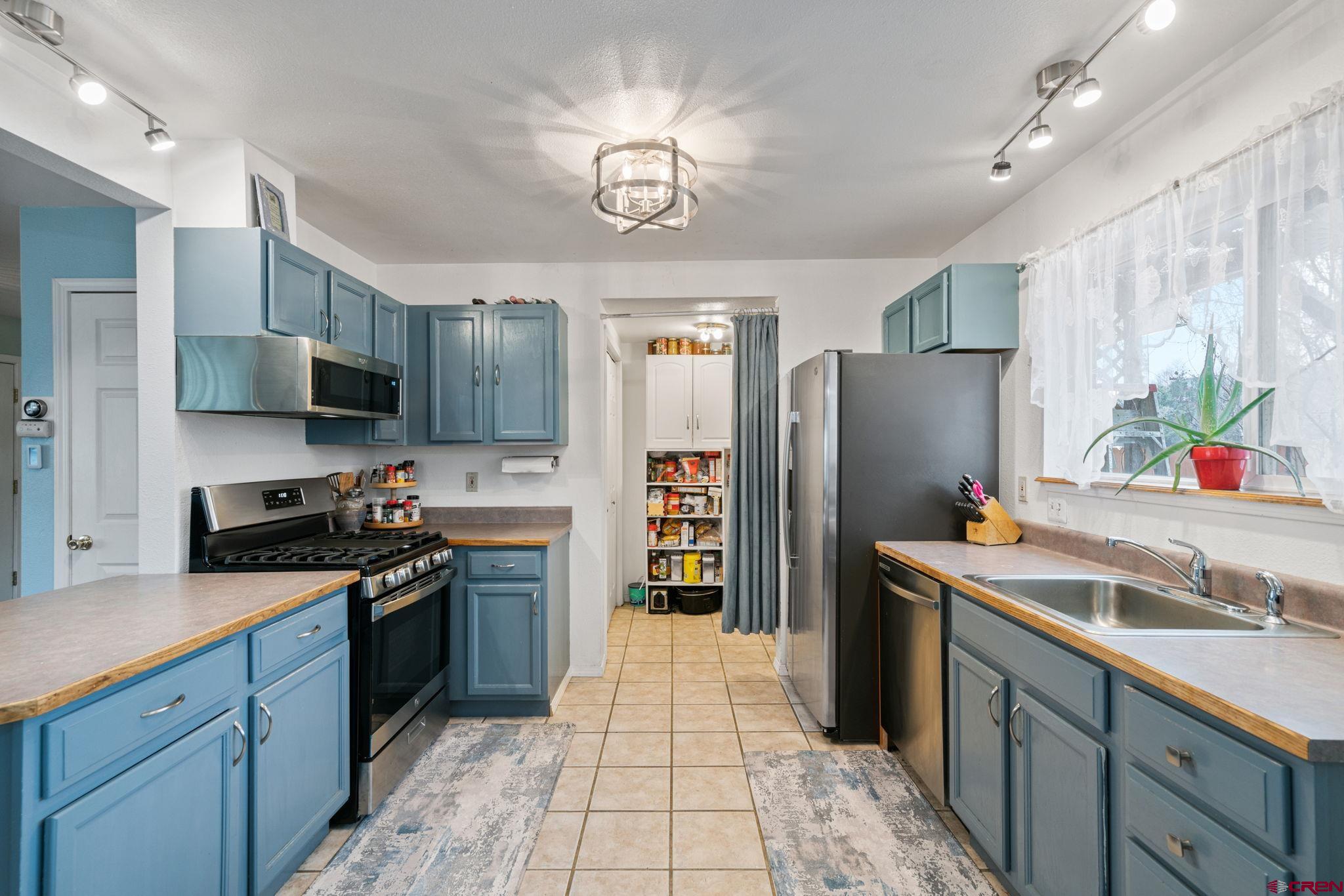 233 Jenkins Ranch Road, Unit B Durango, CO 81301 - Photo 7 of 20 a kitchen with stainless steel appliances granite countertop a refrigerator and a stove