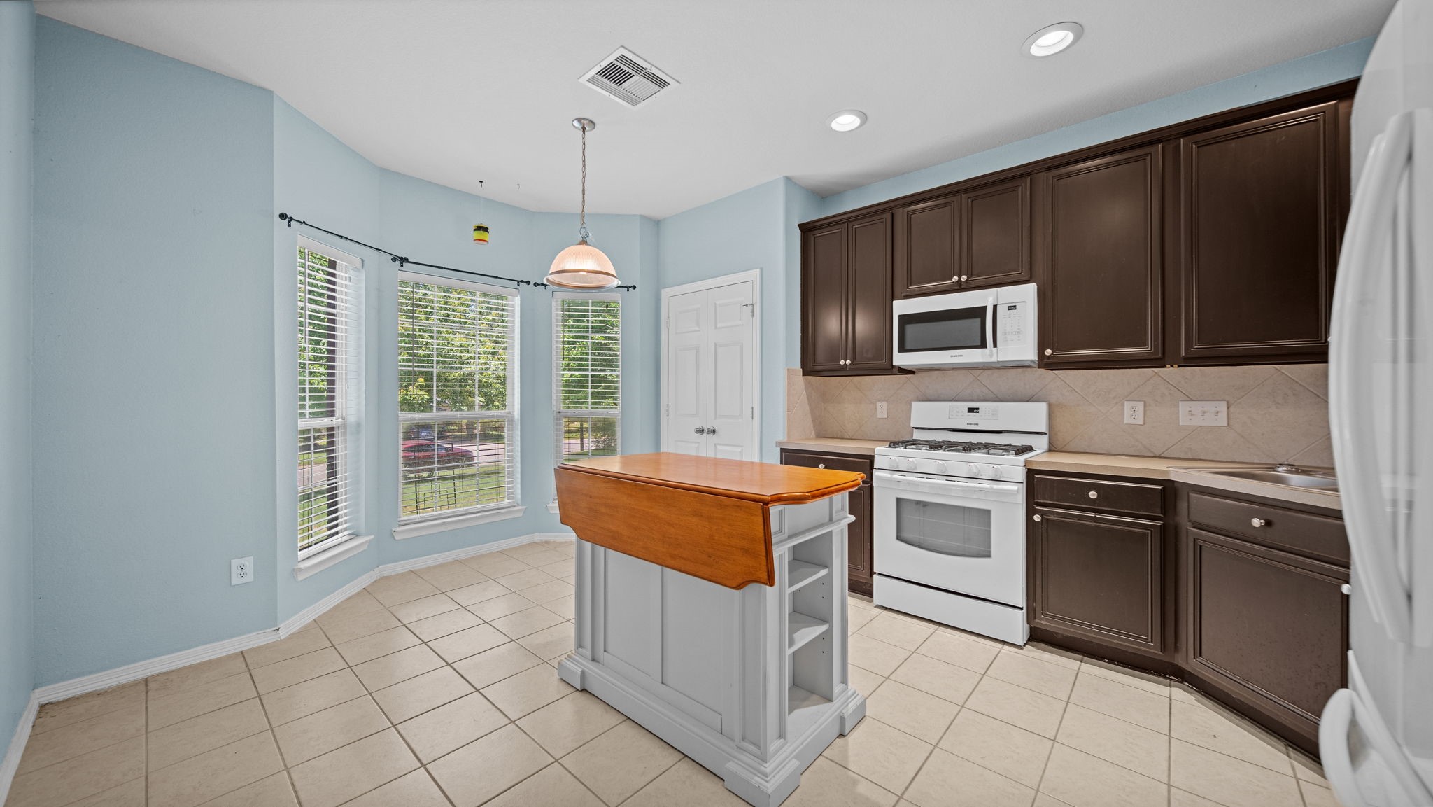 213 Mesa View Conroe, TX 77316 - Photo 6 of 19 a kitchen with stainless steel appliances granite countertop a stove top oven a sink and a granite counter tops