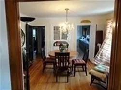 a dining room with furniture window and wooden floor