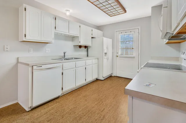 an empty room with a window and a ceiling fan