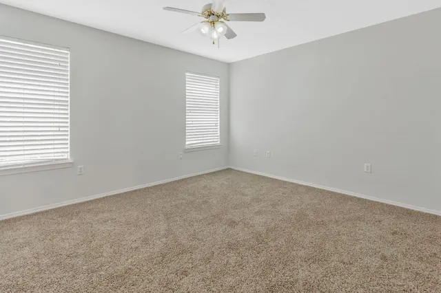 a view of a livingroom with a chandelier fan