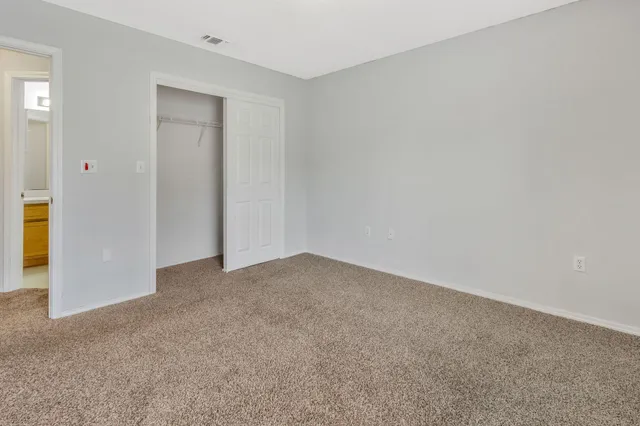 a view of an empty room and closet area