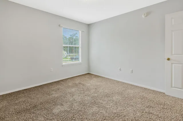 a view of a house with backyard and a chair