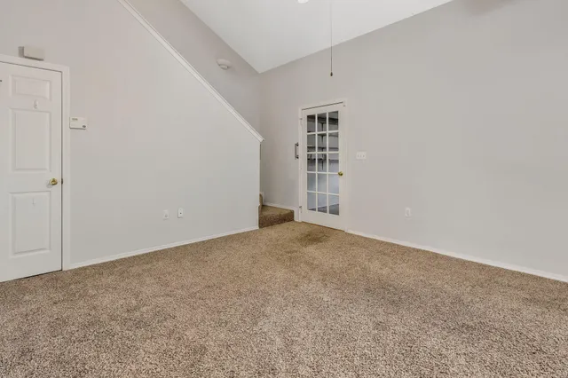 a view of an empty room with a closet