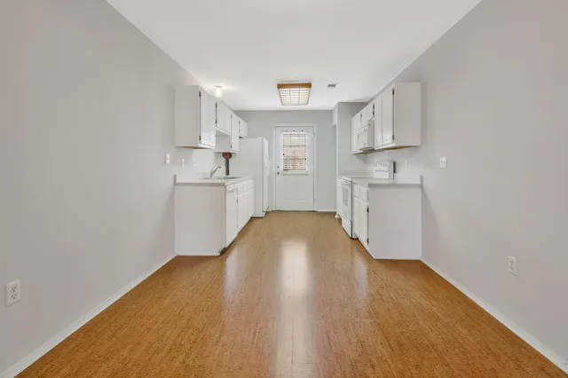 a view of cabinets and wooden floor